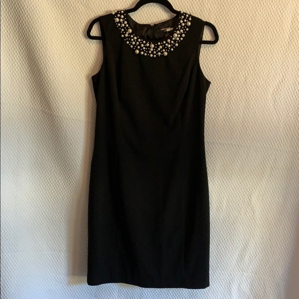 Black dress with pearl neckline detail. Size 8.